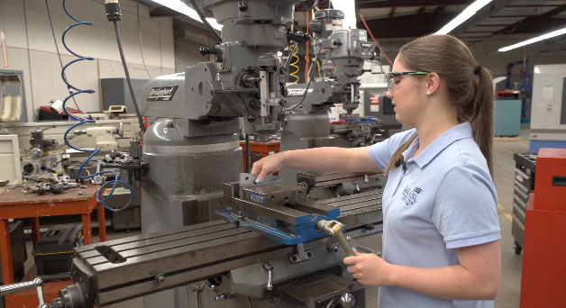 A female student working at a machine